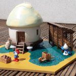A mushroom-shaped granary with corn crib, wheelbarrow and smurf figurines