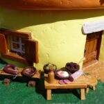 sausages and food outside a miniature mushroom house
