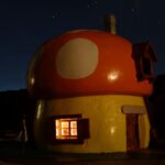 mushroom house by night lit from inside