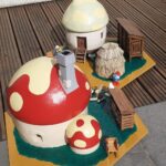 miniature mushroom houses with smurf figurines
